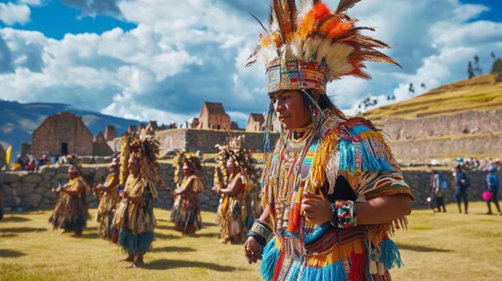 A person in vibrant traditional attire with colorful feathers and patterns is in focus, dancing in front of ancient stone ruins under a cloudy blue sky.