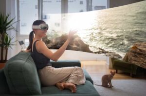 A person experiencing VR Travel of tranquil ocean scene through VR headset while seated on a couch.